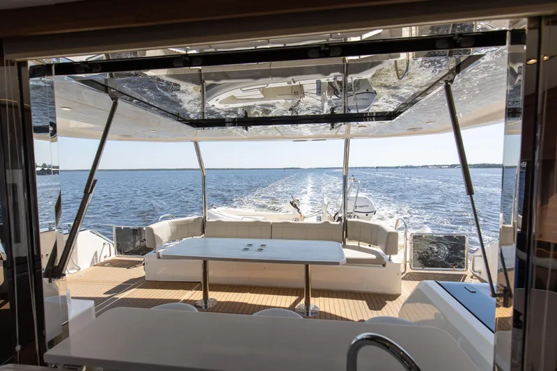 Slide: The Image of Aquila 54 Yacht 2022, luxurious deck view over serene ocean waters. - 21