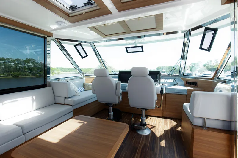 Slide: The Image of Luxurious interior of 2022 Aquila 54 Yacht with modern seating and panoramic windows. - 23