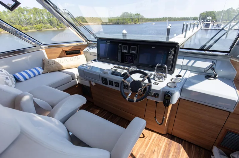 Slide: The Image of Luxurious helm of 2022 Aquila 54 Yacht with modern controls and scenic water view. - 24