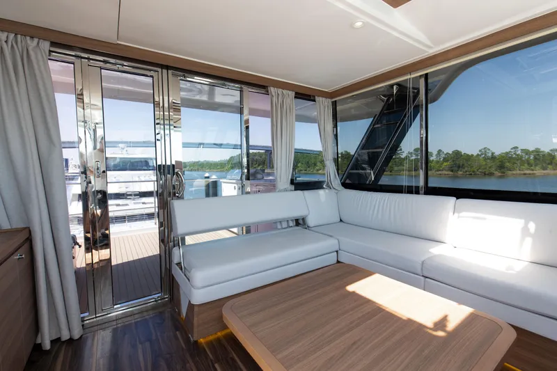 Slide: The Image of Luxurious interior of 2022 Aquila 54 Yacht with white seating and large windows. - 26