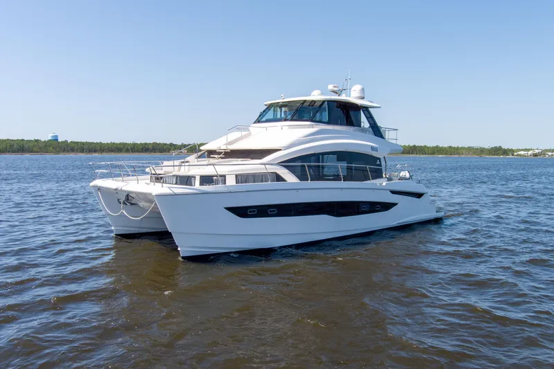 Slide: The Image of Aquila 54 Yacht 2022 cruising on open water under clear blue sky. - 4