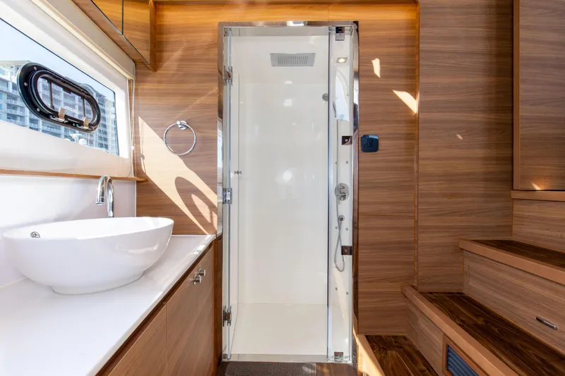 Slide: The Image of Luxurious bathroom interior of 2022 Aquila 54 Yacht with modern fixtures and wooden accents. - 44