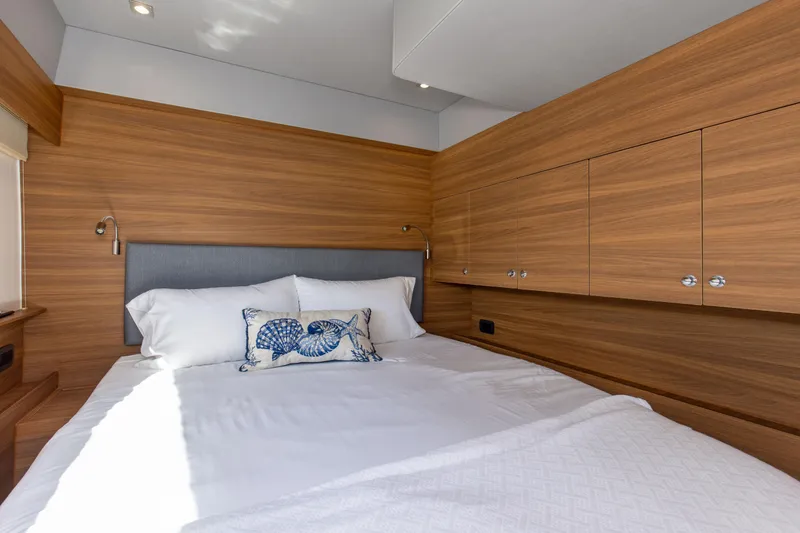 Slide: The Image of Luxurious bedroom interior of 2022 Aquila 54 Yacht with wood paneling and elegant bedding. - 47