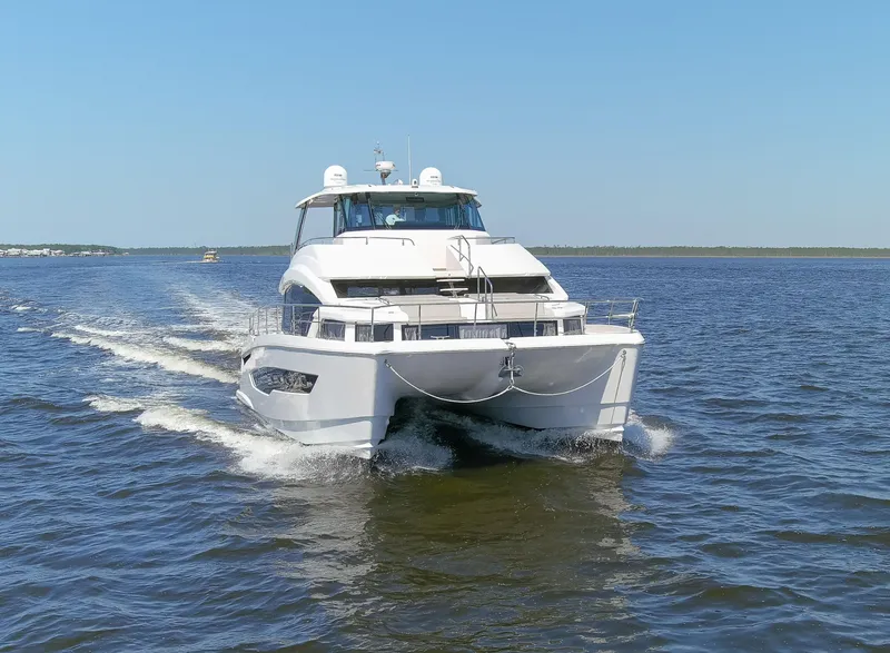 Slide: The Image of Aquila 54 Yacht 2022 cruising on open water under clear blue sky. - 5