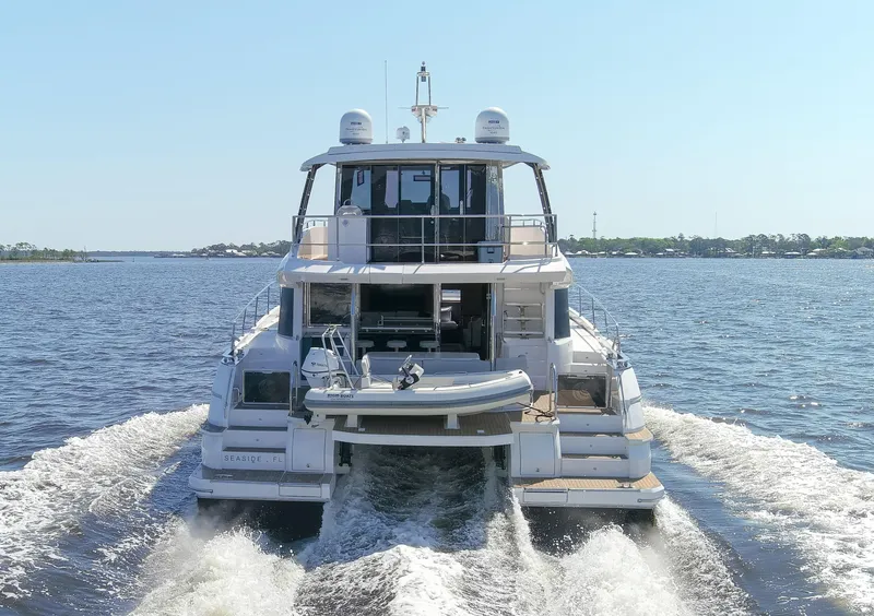 Slide: The Image of Aquila 54 Yacht 2022 cruising on open water, rear view. - 8