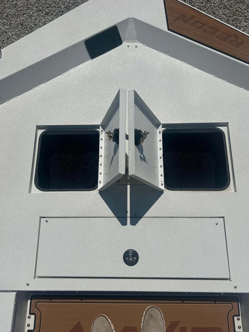 Slide: The Image of Avid 22 Recon 2025 boat deck with storage compartments and sleek design. - 13