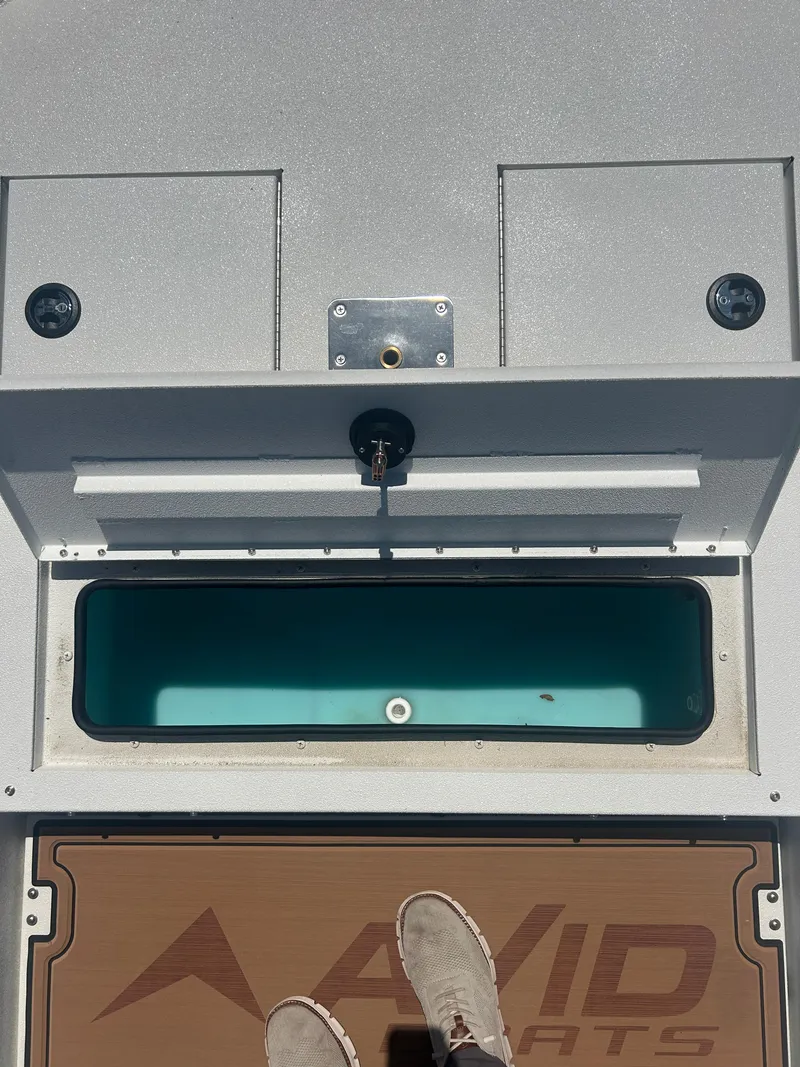 Slide: The Image of Avid 22 Recon boat deck with storage compartment, 2025 model. - 14
