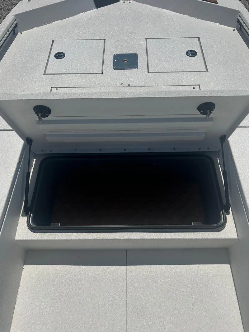 Slide: The Image of Open storage compartment on 2025 Avid 22 Recon boat, showcasing interior space. - 16