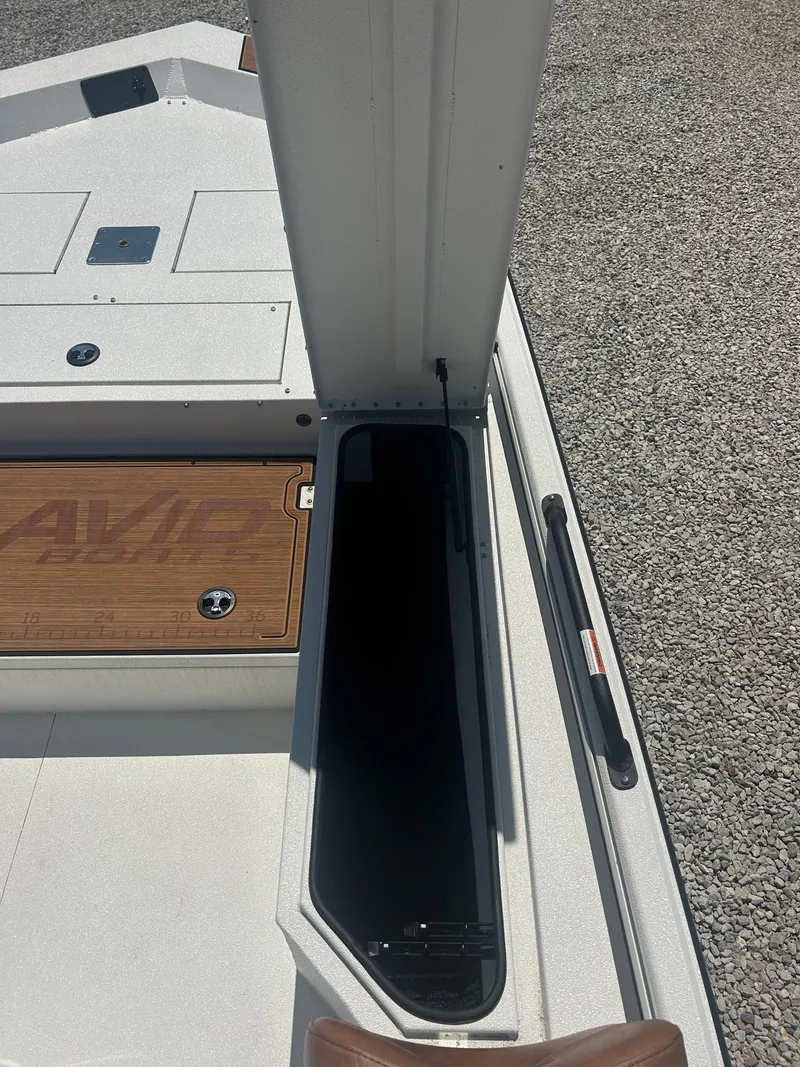 Slide: The Image of Avid 22 Recon 2025 boat interior with storage compartment and deck details. - 17
