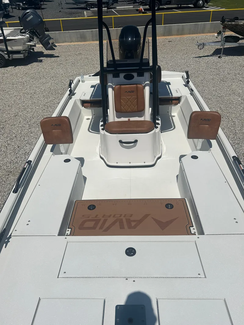 Slide: The Image of 2025 Avid 22 Recon boat interior with brown seating and white deck. - 19