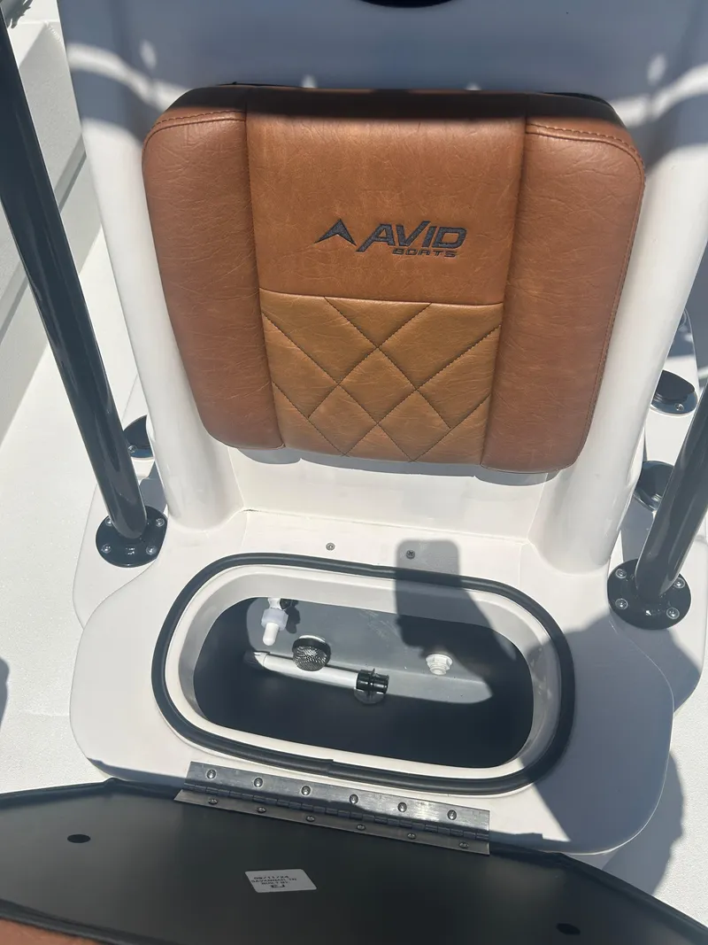 Slide: The Image of Avid 22 Recon 2025 boat seat with storage compartment, featuring brown leather upholstery. - 20