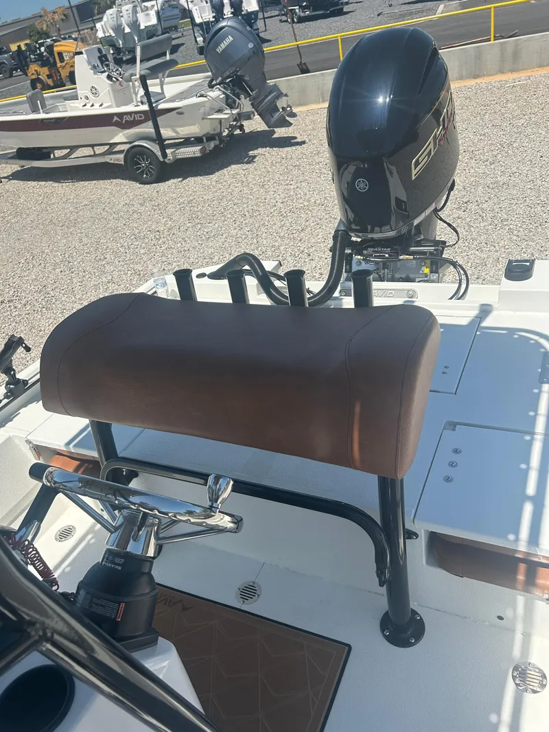 Slide: The Image of 2025 Avid 22 Recon boat with Yamaha outboard motor, featuring a brown cushioned seat. - 22