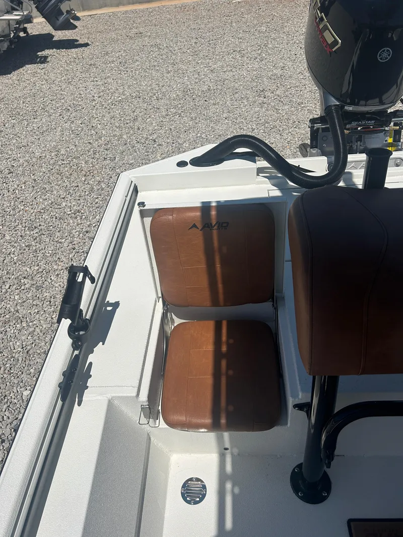 Slide: The Image of 2025 Avid 22 Recon boat interior with brown seats and Yamaha motor. - 25