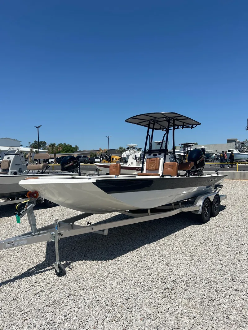 Slide: The Image of 2025 Avid 22 Recon boat on trailer under clear blue sky. - 3