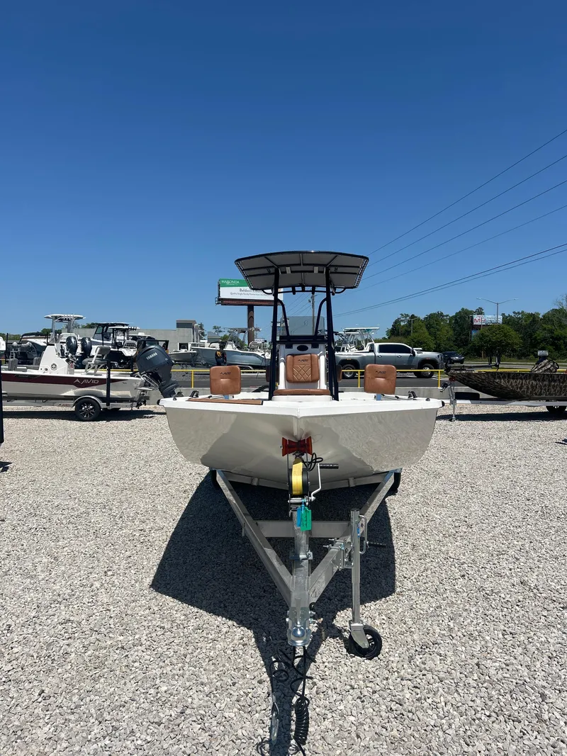 Slide: The Image of 2025 Avid 22 Recon boat on trailer under clear blue sky. - 5
