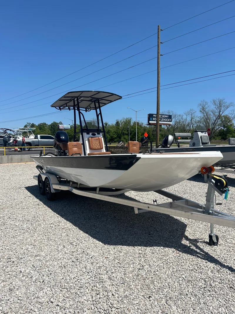 Slide: The Image of 2025 Avid 22 Recon boat on trailer, parked on gravel under clear blue sky. - 6