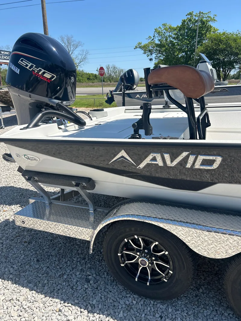 Slide: The Image of 2025 Avid 22 Recon boat on trailer with Yamaha engine, parked on gravel. - 7
