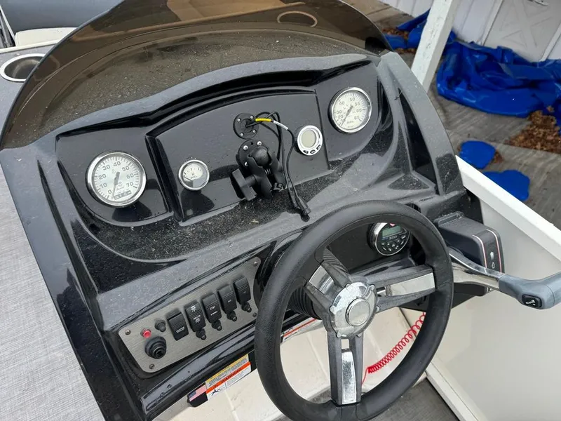 Slide: The Image of Dashboard of a 2017 Larson Escape Cruze boat with steering wheel and gauges. - 11