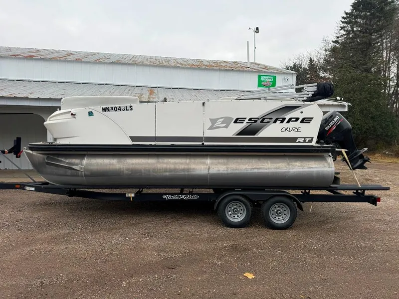 Slide: The Image of 2017 Larson Escape Cruze pontoon boat on trailer, parked outdoors. - 5