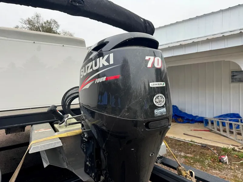 Slide: The Image of Suzuki 70 horsepower outboard motor on a 2017 Larson Escape Cruze boat. - 6