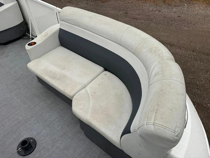Slide: The Image of 2017 Larson Escape Cruze boat seat with white and gray upholstery on deck. - 9