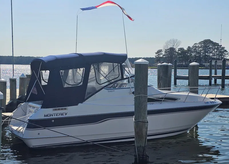 Slide: The Image of 1995 Monterey 246 SEL cruiser docked at marina with canopy and flag. - 3