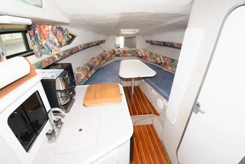 Slide: The Image of Interior of a 1995 Monterey 246 SEL cruiser with kitchenette and seating area. - 8