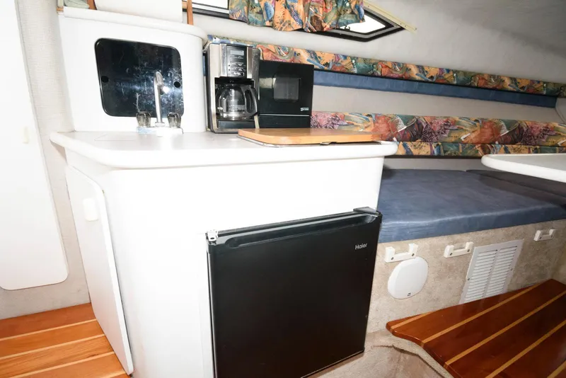 Slide: The Image of Interior of 1995 Monterey 246 SEL cruiser with kitchenette and seating area. - 9