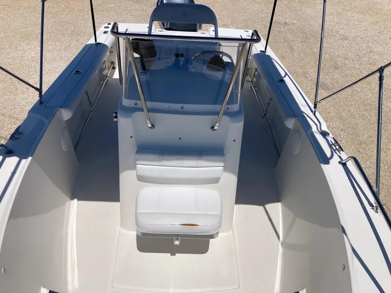Slide: The Image of 2007 Edgewater 205CC boat interior with white seating and console. - 10