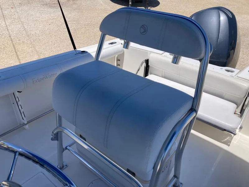 Slide: The Image of 2007 Edgewater 205CC boat interior with cushioned seating and steering wheel. - 13