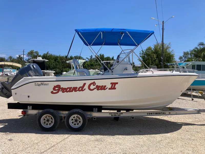Slide: The Image of 2007 Edgewater 205CC boat with blue canopy on trailer, labeled "Grand Cru II." - 2