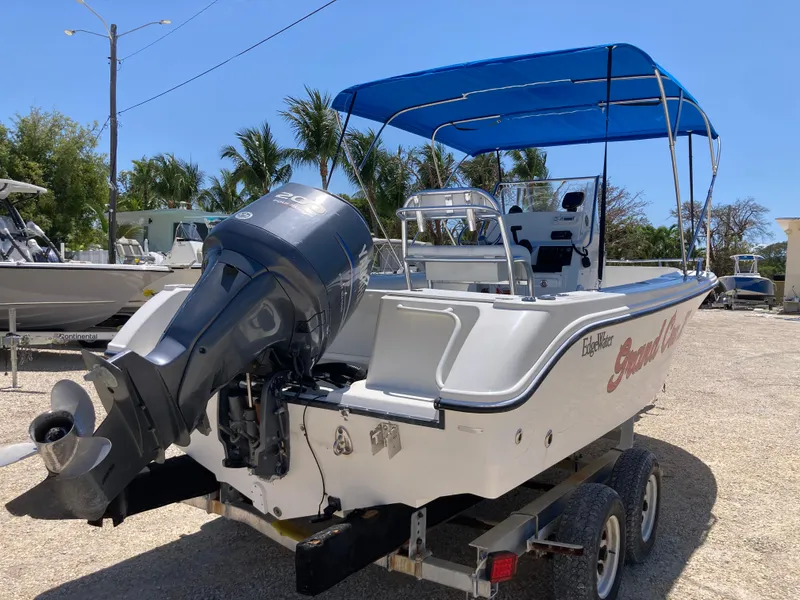 Slide: The Image of 2007 Edgewater 205CC boat with blue canopy on trailer, parked outdoors. - 3