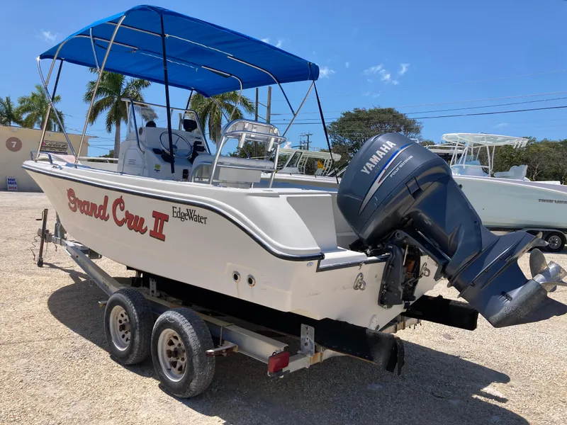 Slide: The Image of 2007 Edgewater 205CC boat with Yamaha motor and blue canopy on a trailer. - 4