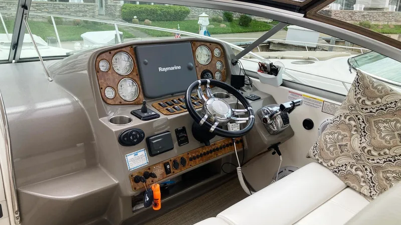 Slide: The Image of 2008 Rinker 400 Express Cruiser helm with steering wheel, gauges, and navigation system. - 10