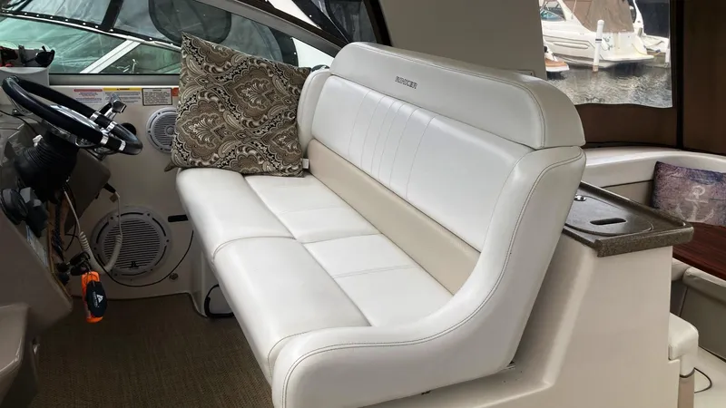 Slide: The Image of 2008 Rinker 400 Express Cruiser interior with white leather seating and patterned cushion. - 11