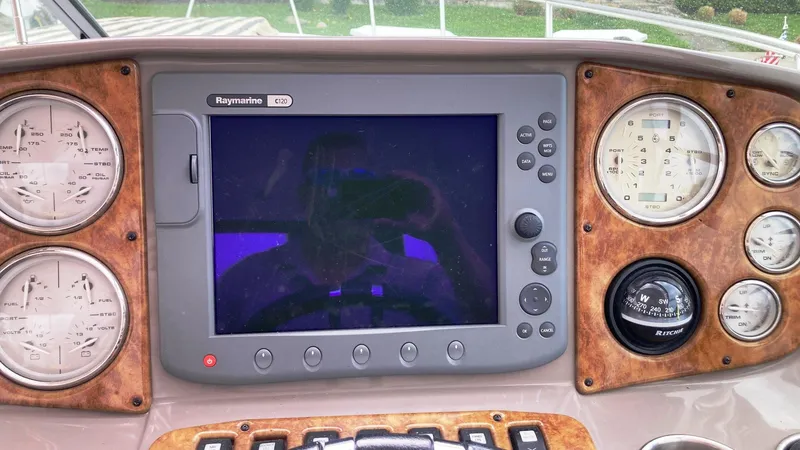 Slide: The Image of Dashboard of 2008 Rinker 400 Express Cruiser with Raymarine GPS and gauges. - 12