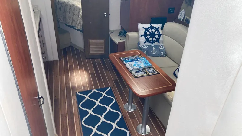 Slide: The Image of 2008 Rinker 400 Express Cruiser interior with nautical decor and wooden flooring. - 14