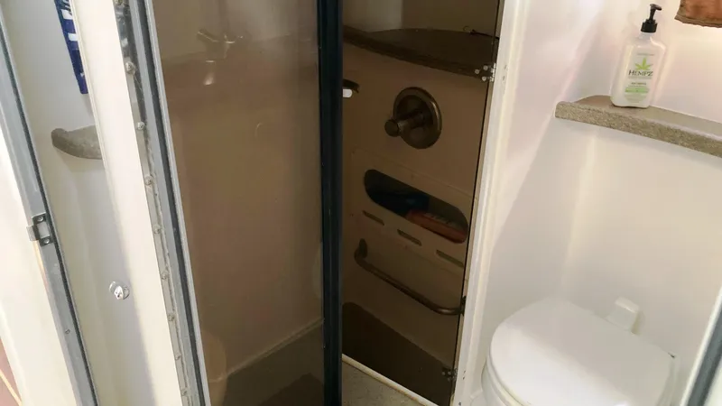 Slide: The Image of 2008 Rinker 400 Express Cruiser bathroom with shower, toilet, and countertop amenities. - 19