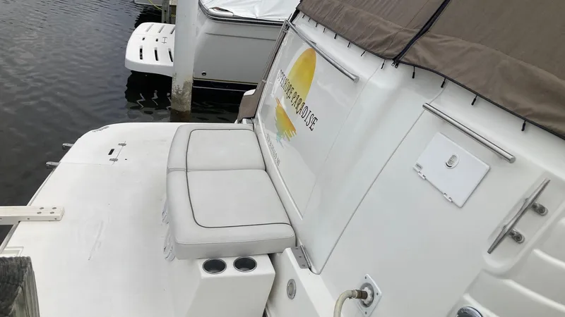 Slide: The Image of 2008 Rinker 400 Express Cruiser docked, featuring rear seating and cup holders. - 2