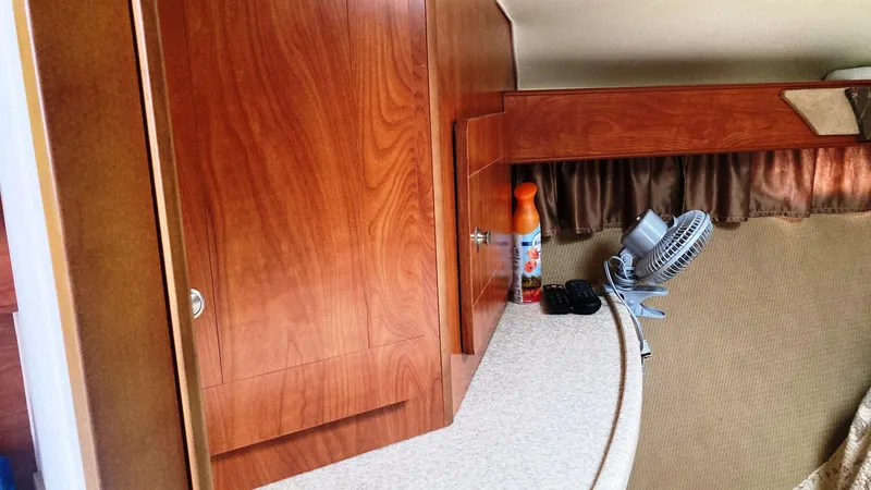 Slide: The Image of 2008 Rinker 400 Express Cruiser interior with wooden cabinets and countertop. - 21
