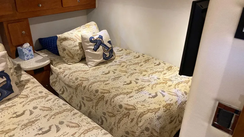 Slide: The Image of 2008 Rinker 400 Express Cruiser cabin with nautical-themed bedding and decor. - 23