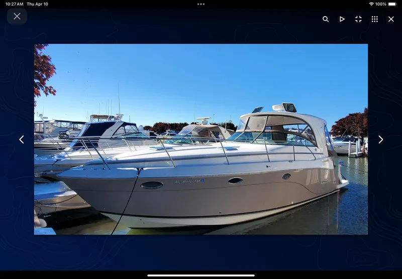 Slide: The Image of 2008 Rinker 400 Express Cruiser docked at a marina under clear blue skies. - 26