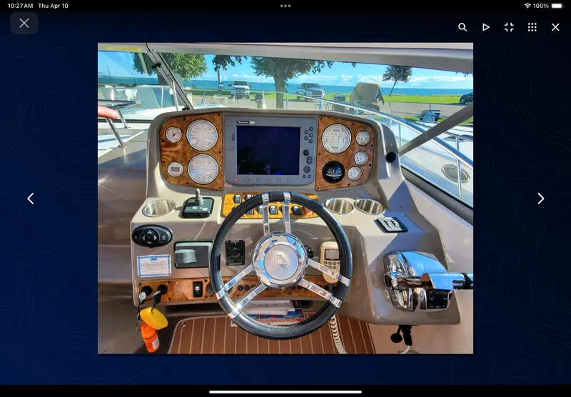 Slide: The Image of 2008 Rinker 400 Express Cruiser helm with gauges, steering wheel, and navigation display. - 28