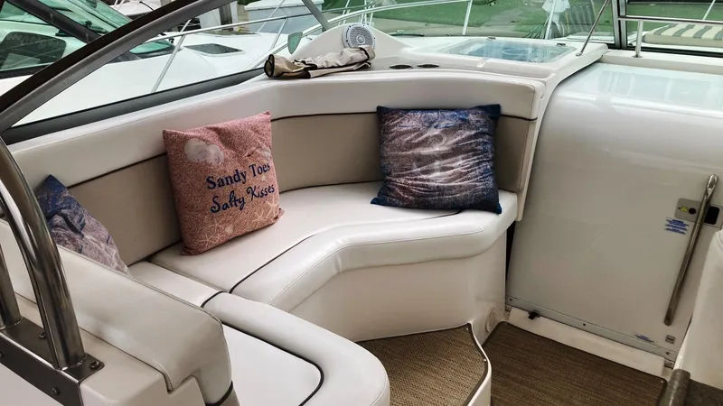 Slide: The Image of 2008 Rinker 400 Express Cruiser interior with cushioned seating and decorative pillows. - 6