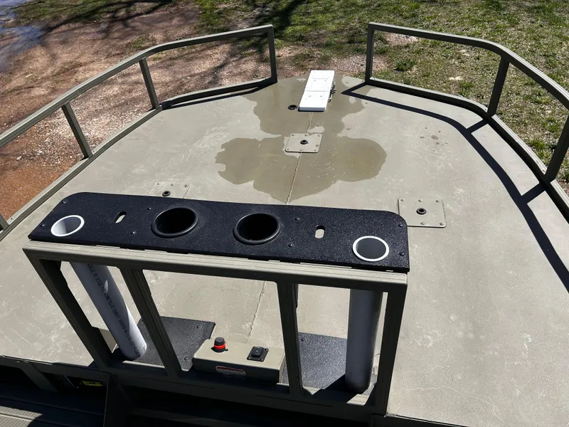 Slide: The Image of 2024 Tracker Grizzly 2072 CC Sportsman boat deck with rod holders and railing. - 10