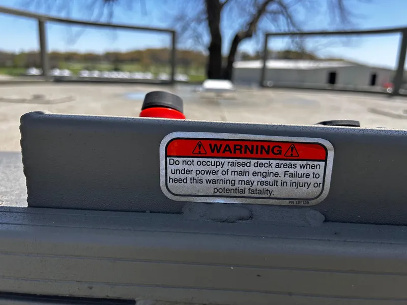 Slide: The Image of Warning label on 2024 Tracker Grizzly 2072 CC Sportsman boat deck, safety caution. - 15