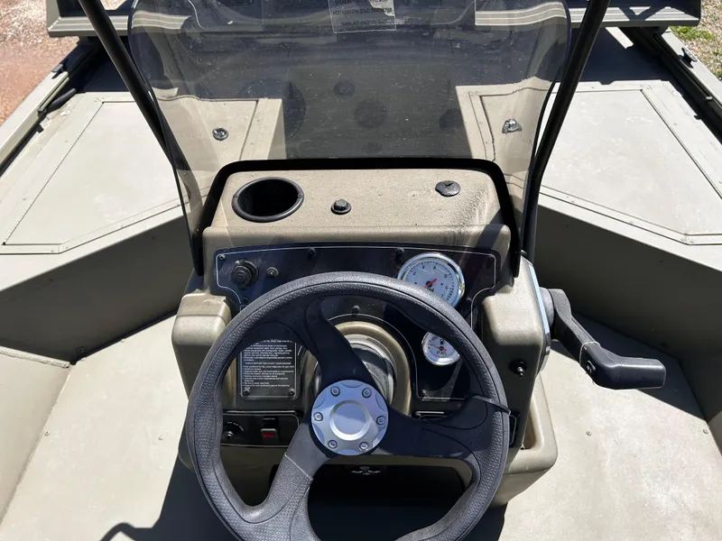 Slide: The Image of 2024 Tracker Grizzly 2072 CC Sportsman boat console with steering wheel and gauges. - 19