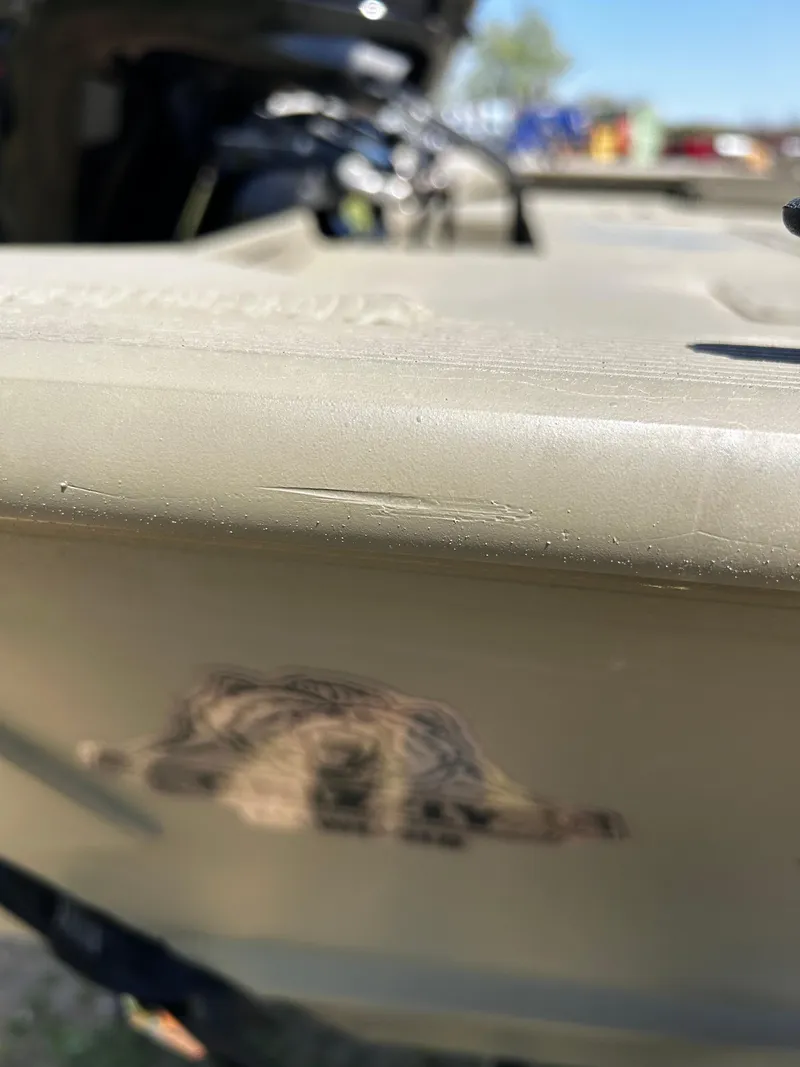 Slide: The Image of 2024 Tracker Grizzly 2072 CC Sportsman boat, close-up of hull with logo. - 23