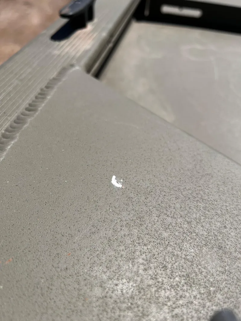 Slide: The Image of 2024 Tracker Grizzly 2072 CC Sportsman boat surface with minor scratch detail. - 26