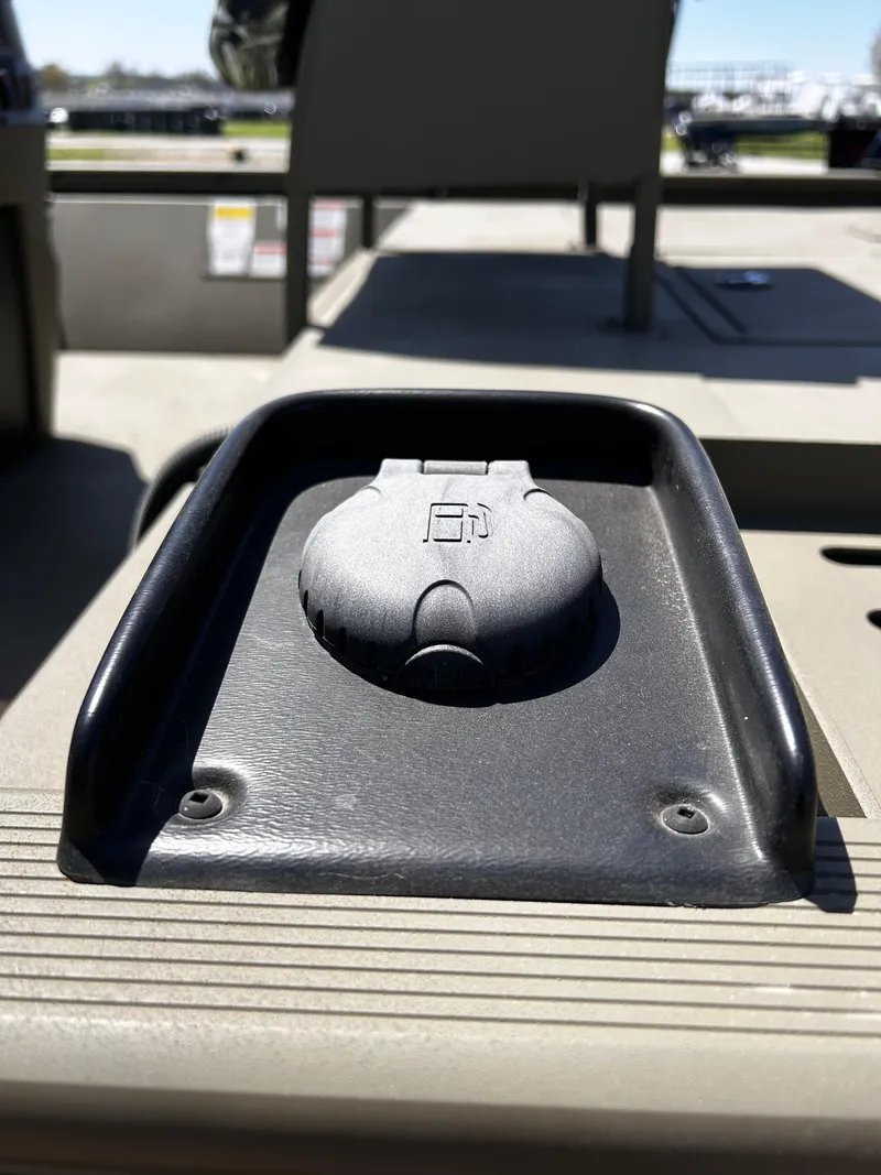 Slide: The Image of 2024 Tracker Grizzly 2072 CC Sportsman boat detail, featuring a black plastic cover on deck. - 6